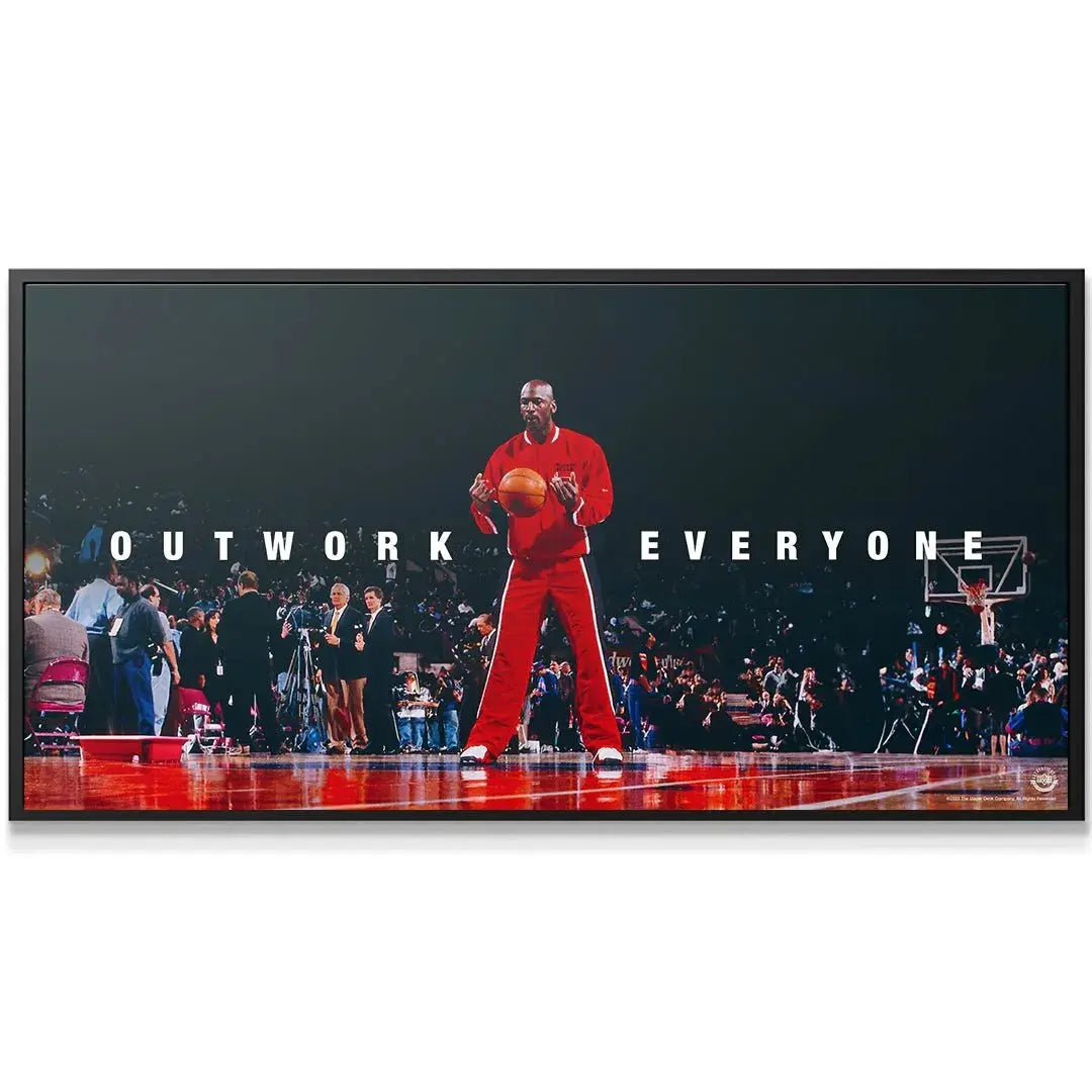 Close-up of Michael Jordan holding the basketball in the powerful "Outwork Everyone" motivational print.