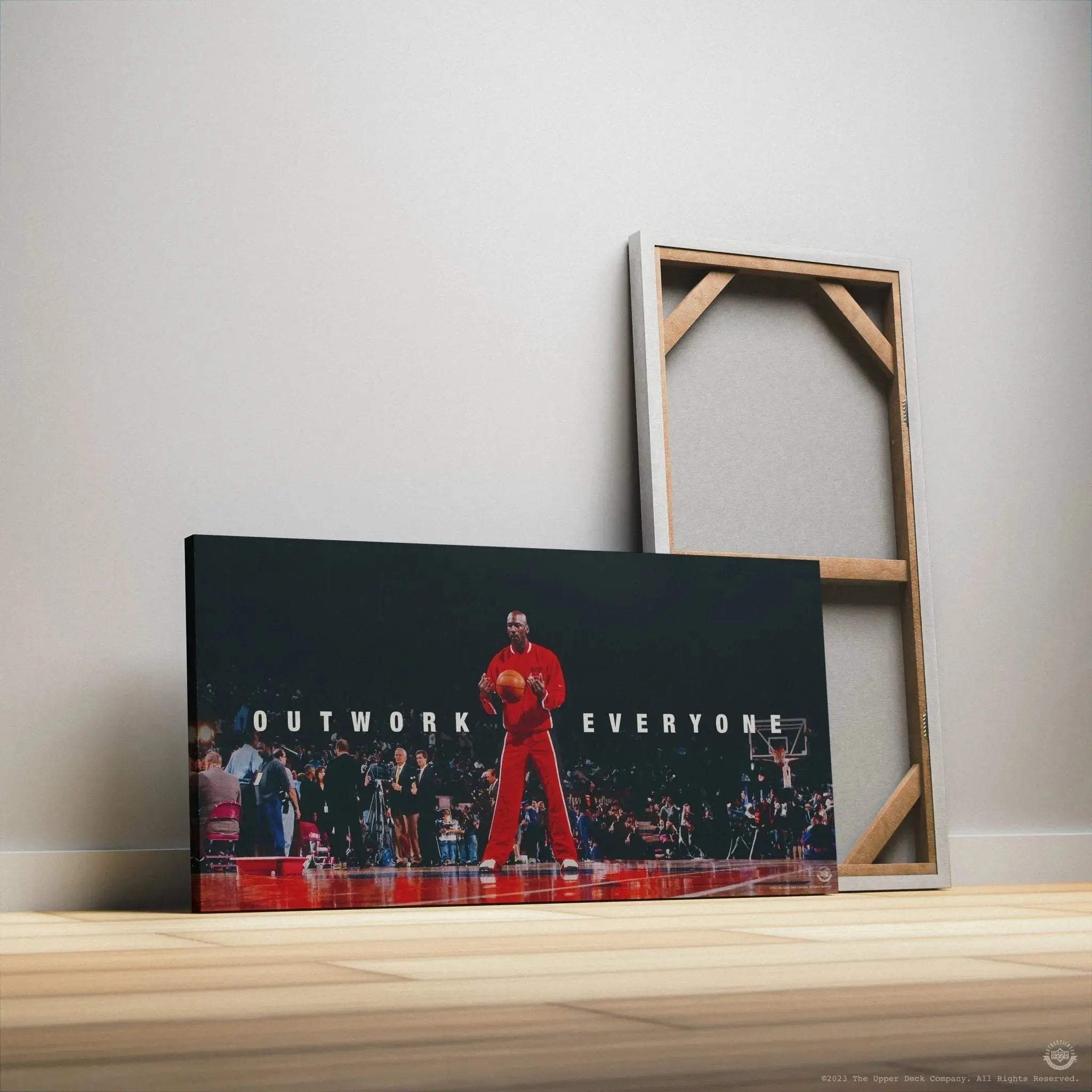 Detail of the bold, capitalized "Outwork Everyone" text lettering adjacent to legendary Michael Jordan.