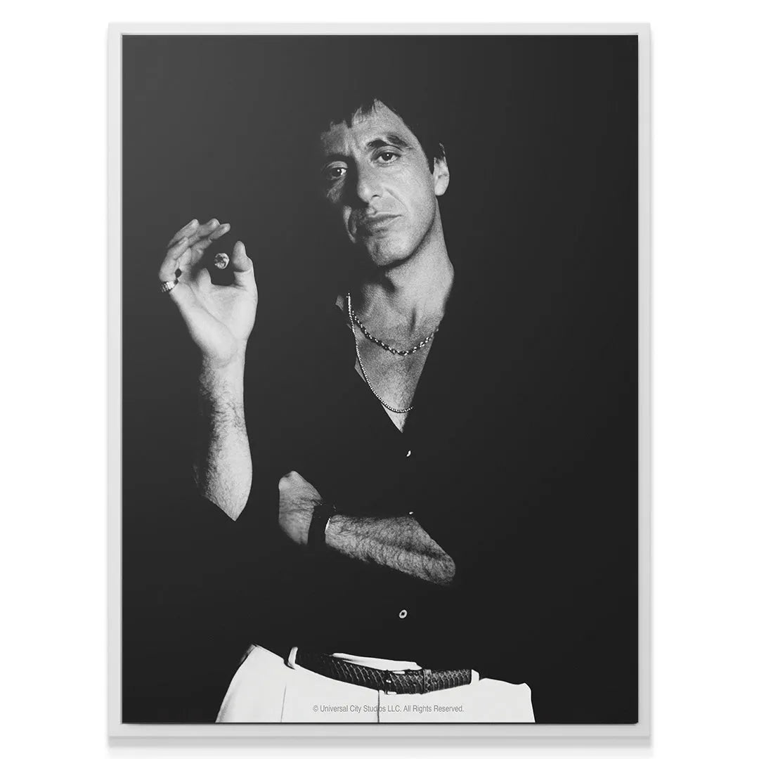 Tony Montana in classic 80s attire featured in the 'Scarface - Smoke' artwork with arms crossed.