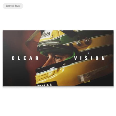 Close-up profile of Ayrton Senna looking forward in his helmet, highlighting the intensity of 'Senna - Clear Vision'.