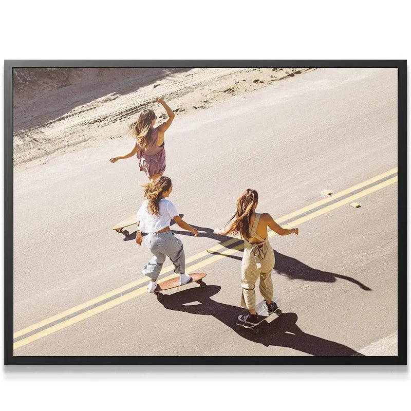 Lifestyle art print featuring friends riding a cruiser Skate board on a sunny desert road.