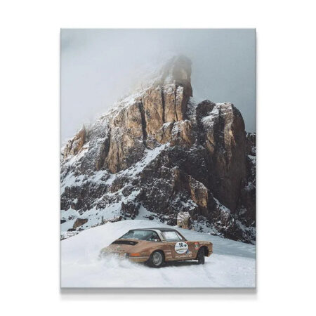 Classic Porsche rally car kicking up snow spray on a challenging mountain 'Snow Day'.