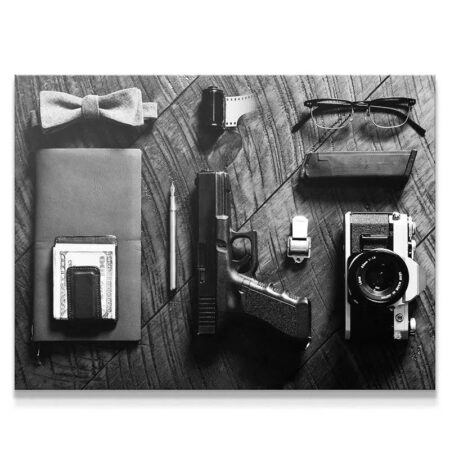 Close-up of the handgun and fountain pen among the necessary Spy Essentials tools.