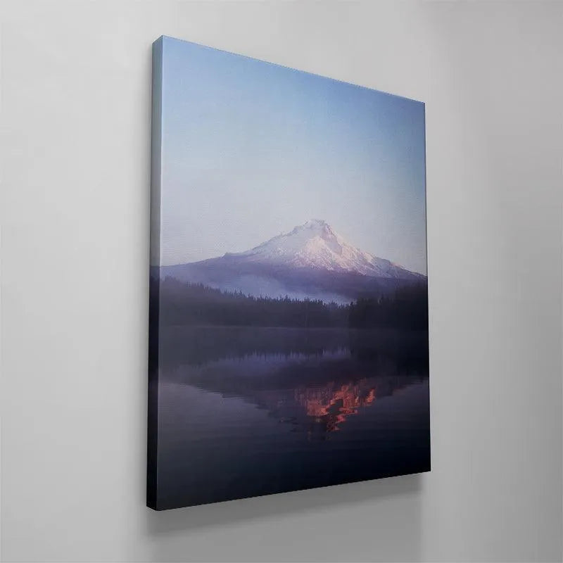 Vertical orientation view of the quiet, deep blue water mirroring the faint glow of the Sunrise at Mt.Hood.