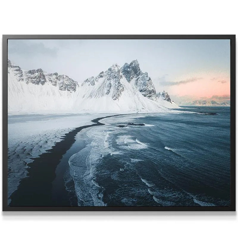 Detail shot of the black sand beach curvature meeting the ocean waves at Sunrise at stokksnes.