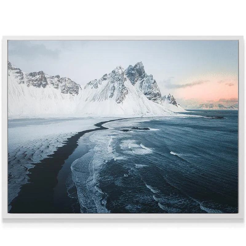 Close-up texture of foam and dark blue water waves during the powerful Sunrise at stokksnes.