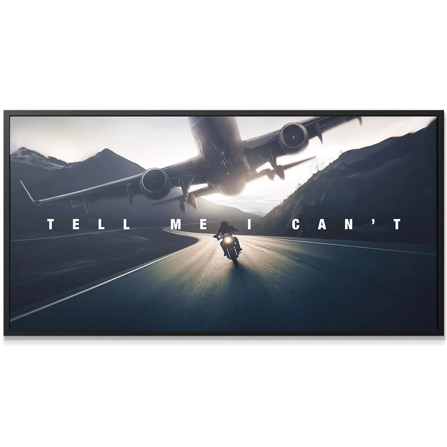Close-up of the textured canvas surface highlighting the crisp white lettering of the phrase "Tell Me I Can't" against the dusk sky.