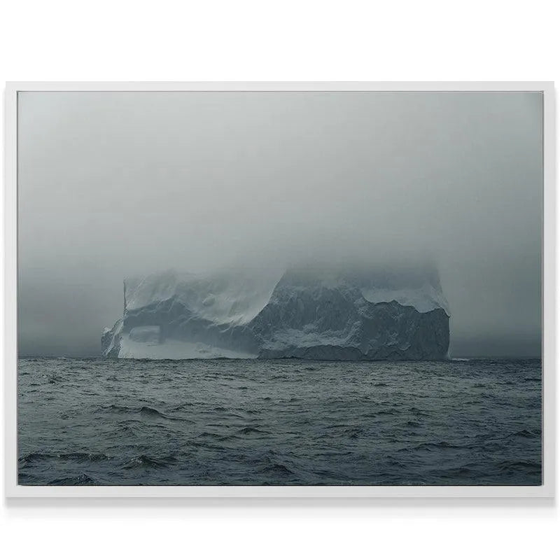 Horizontal view of the vast, choppy gray ocean foreground beneath the colossal ice structure of The Arctic Walls Views.