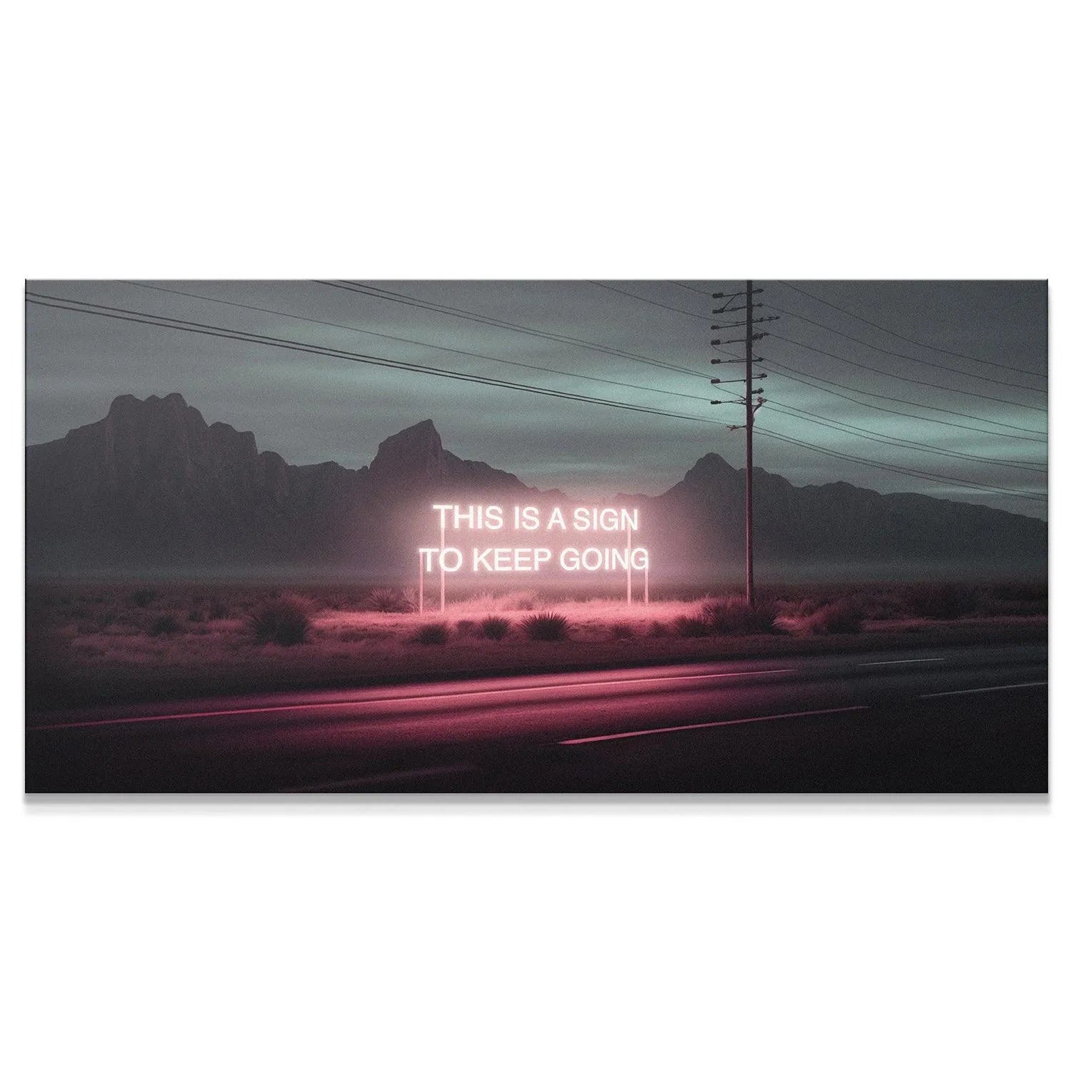 Close-up view of the glowing pink neon text reading "This Is A Sign To Keep Going."