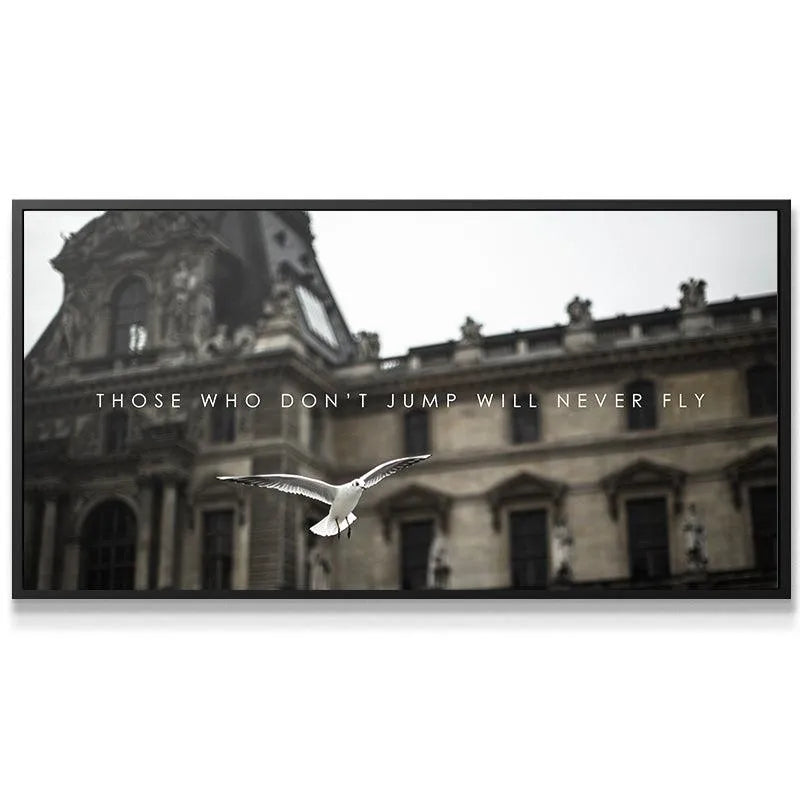 Lifestyle shot of the panoramic motivational artwork 'Those Who Don't Jump' displayed above a modern office desk.