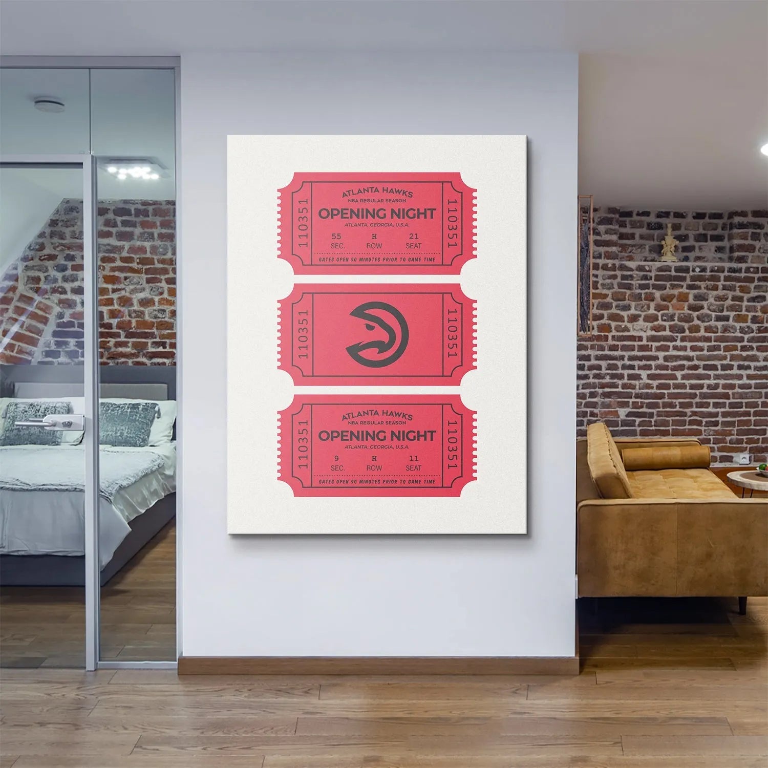 Full vertical view of stacked red Tickets - Hawks canvas art in a modern lifestyle setting with a brick wall.