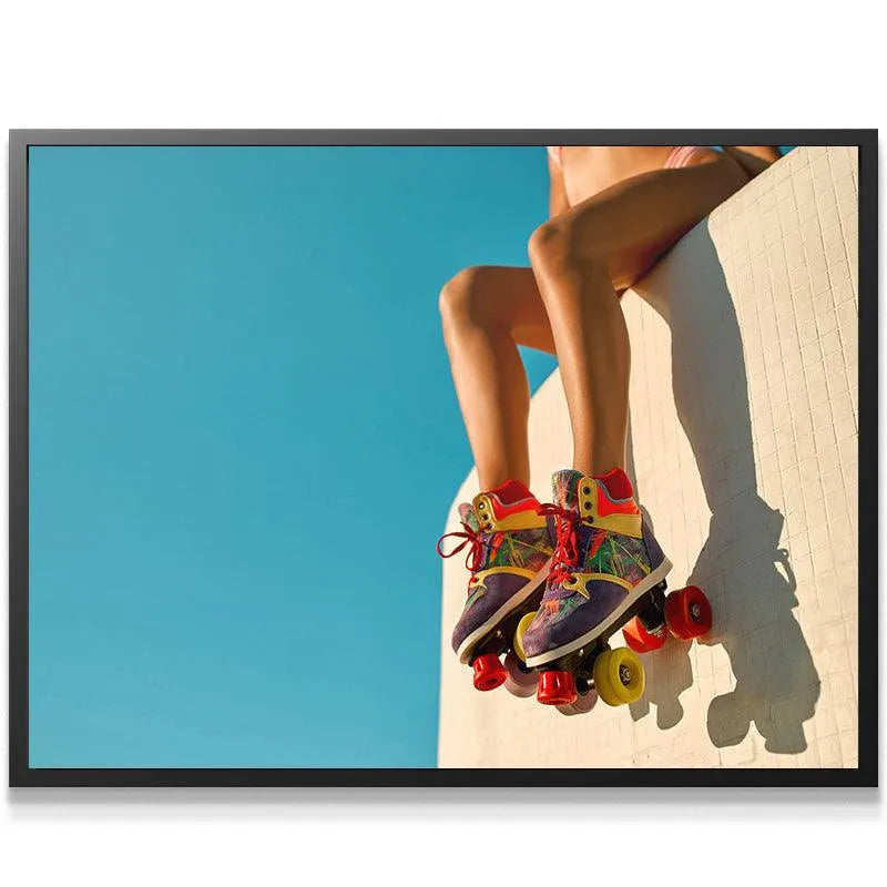 Abstract perspective of vintage skates and legs against a bright blue sky background near Venice Boardwalk.