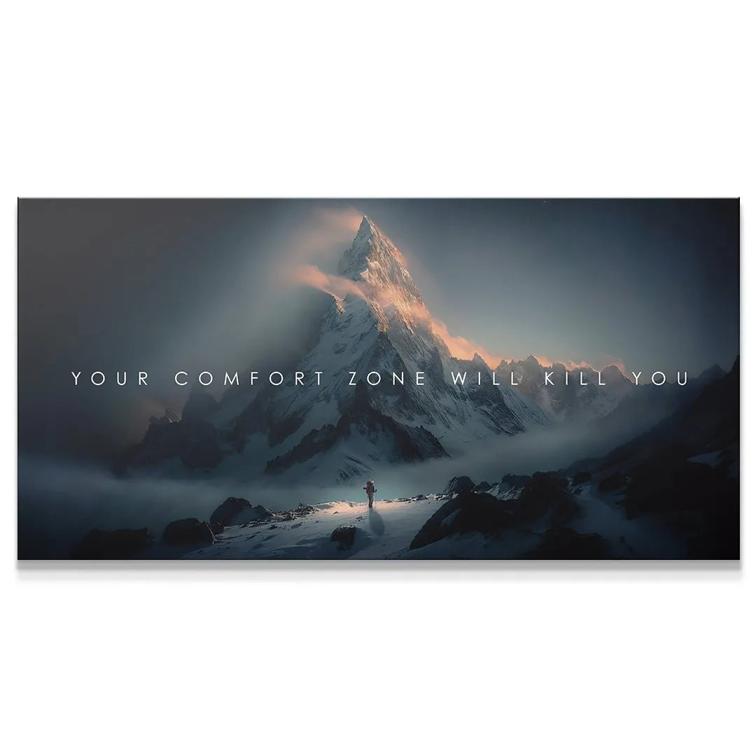 Panoramic view of snow-capped mountains and lone hiker with the quote Your Comfort Zone Will Kill You.